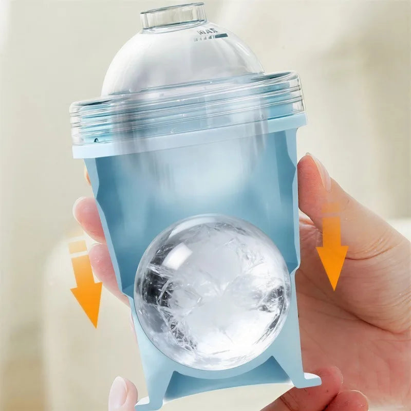 Hand holding a clear silicone ice mold with a large ice cube inside, against a neutral background.