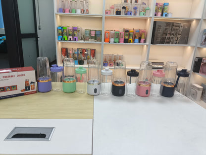 Collection of portable juicers on a counter with shelves in the background.