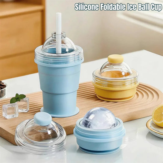 Silicone foldable ice ball cup with a straw on a kitchen counter