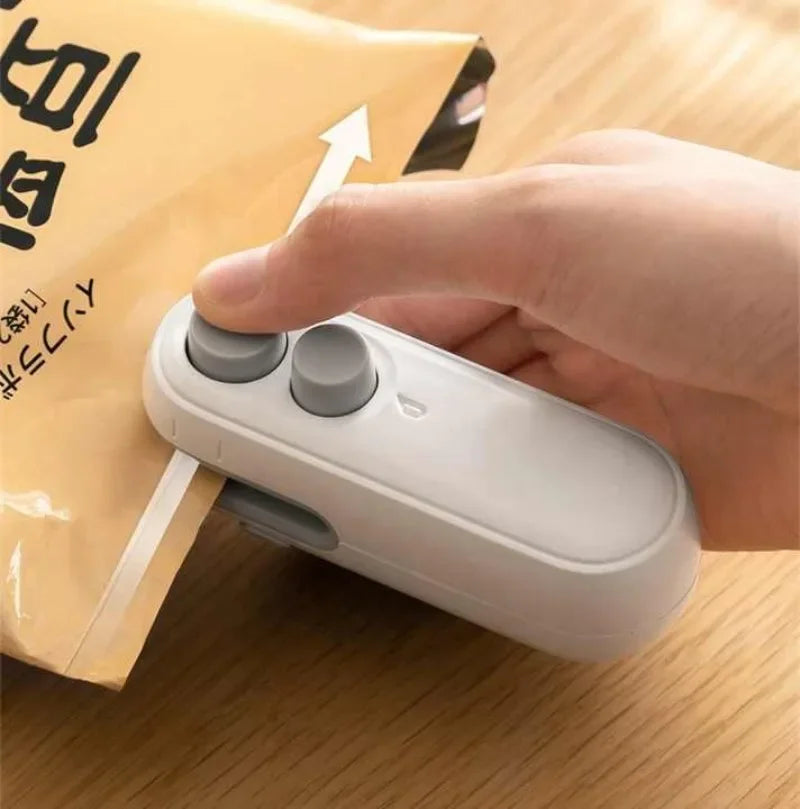 Hand using a white sealing device on a package with Japanese text.