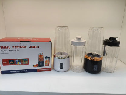 Small portable juicer with packaging on a white surface